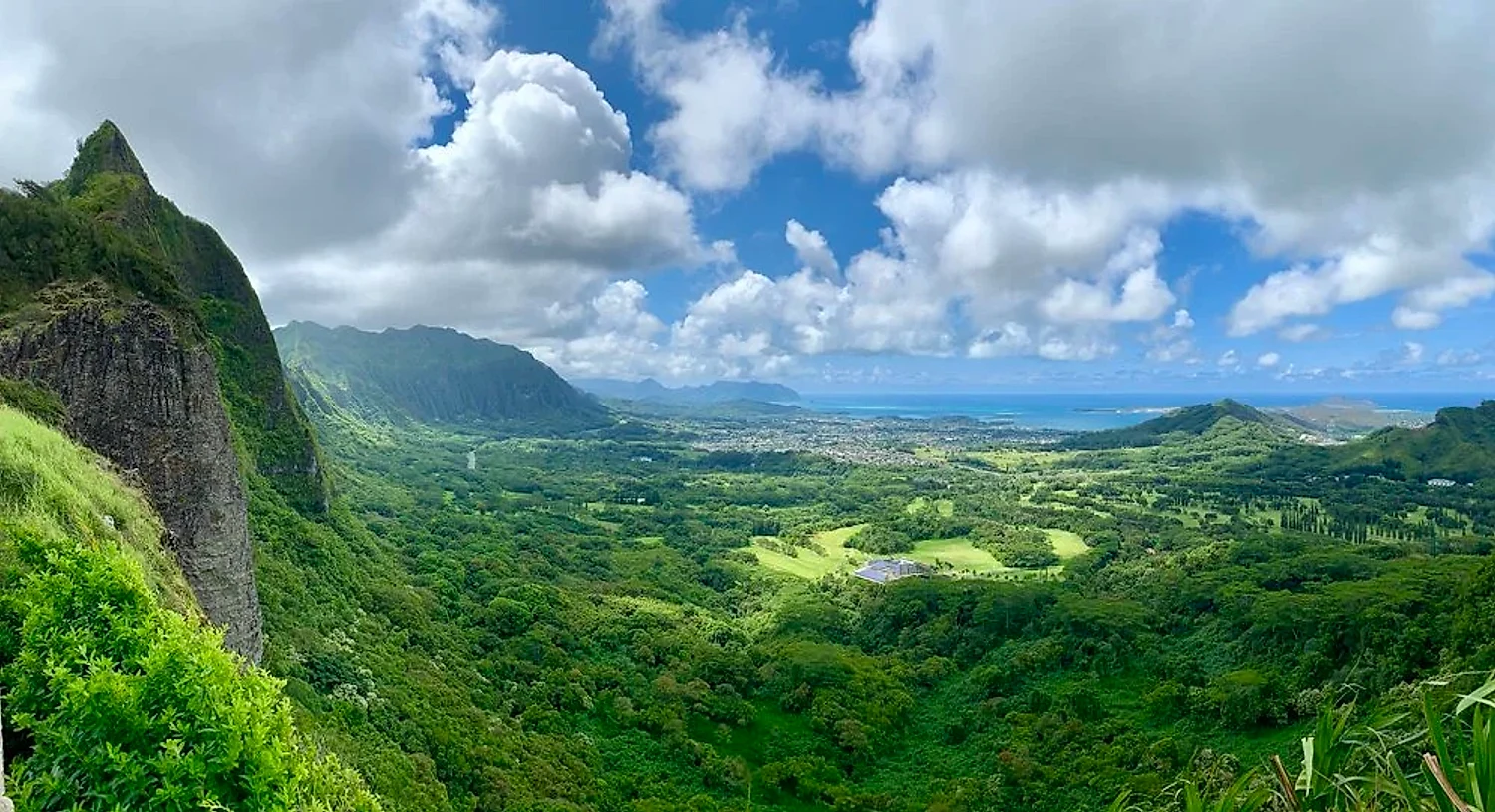 Panoramic Nu'uanu Pali view across a wide valley to the ocean